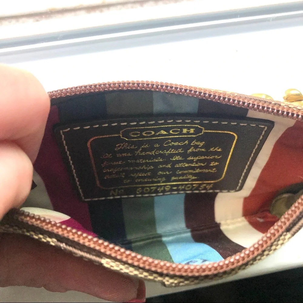 Coach signature tan wristlet, gold strap & stripe